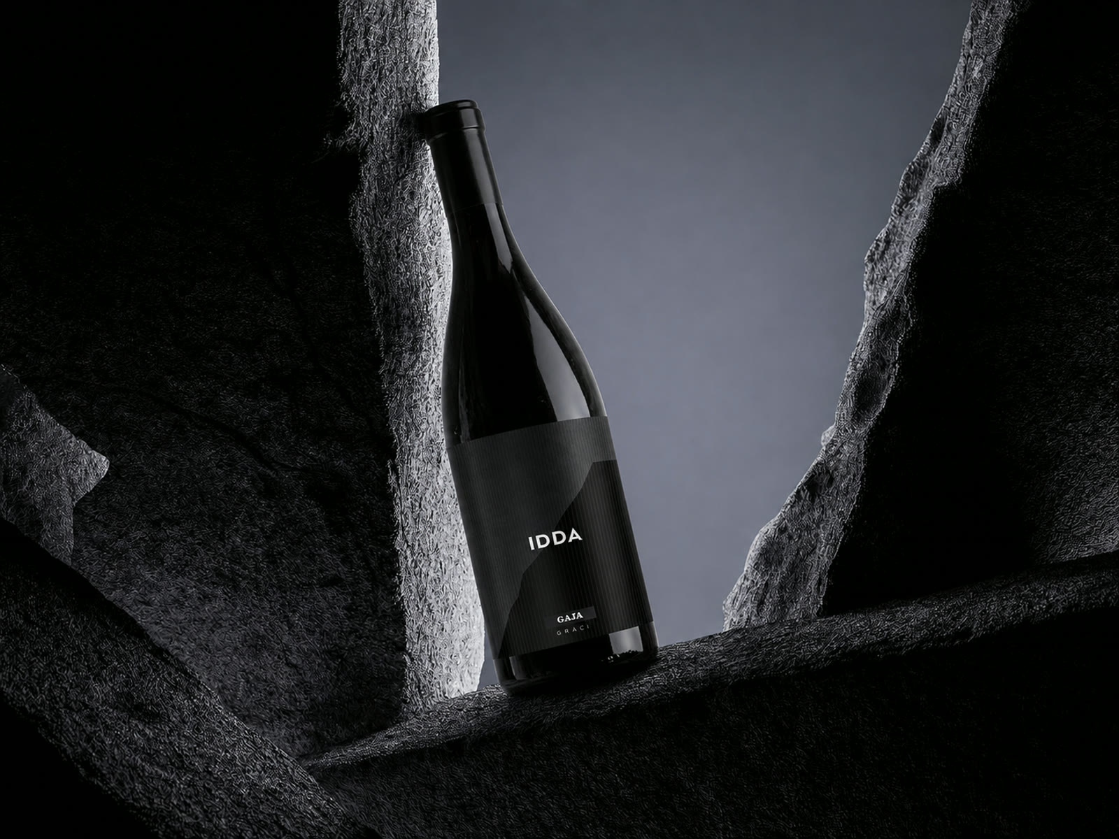 Minimalist black wine bottle packaging in a dark, sculptural set