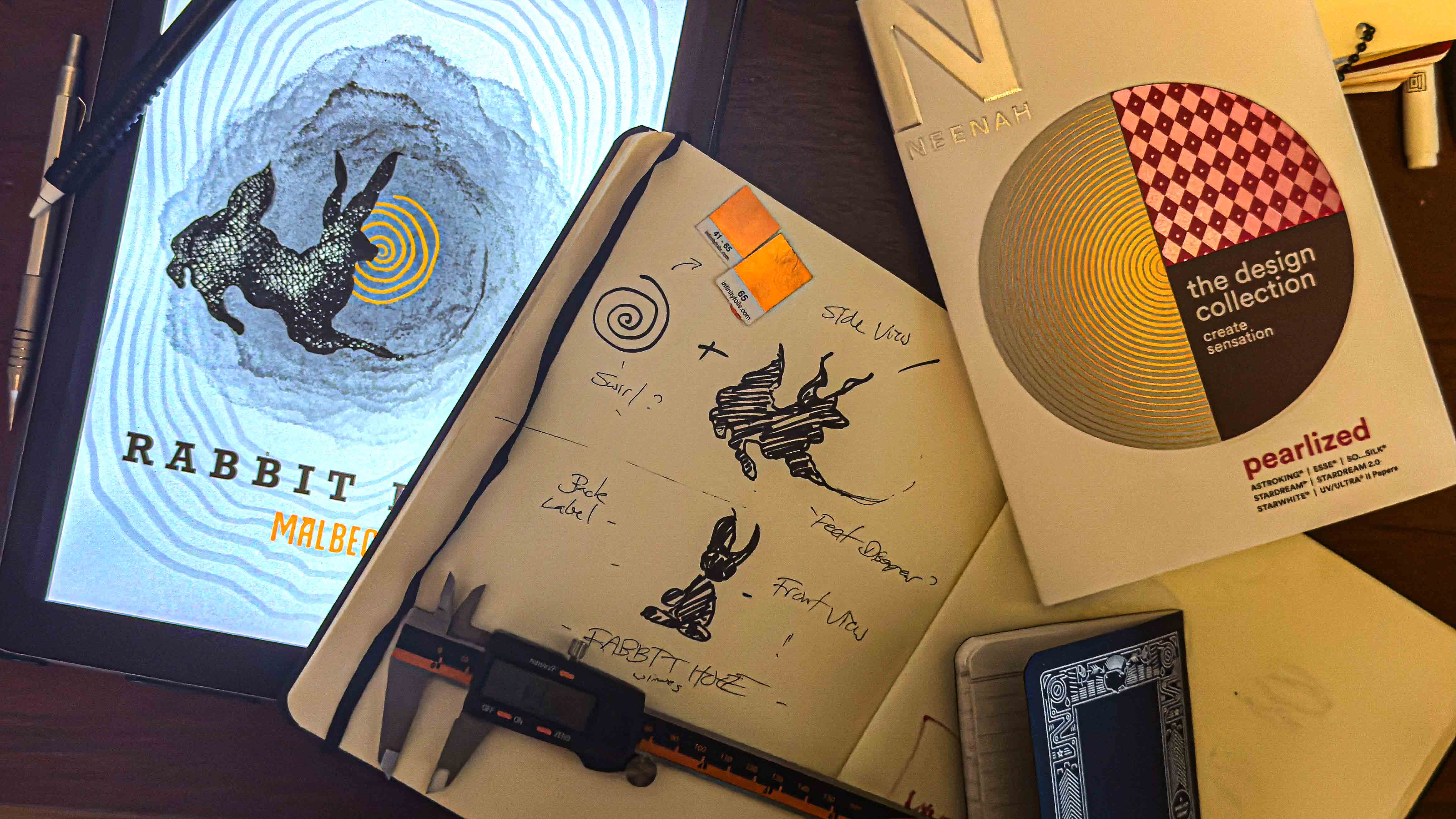 Rabbit Hole Wines — design process: tablet sketch, sketchbook, paper swatches