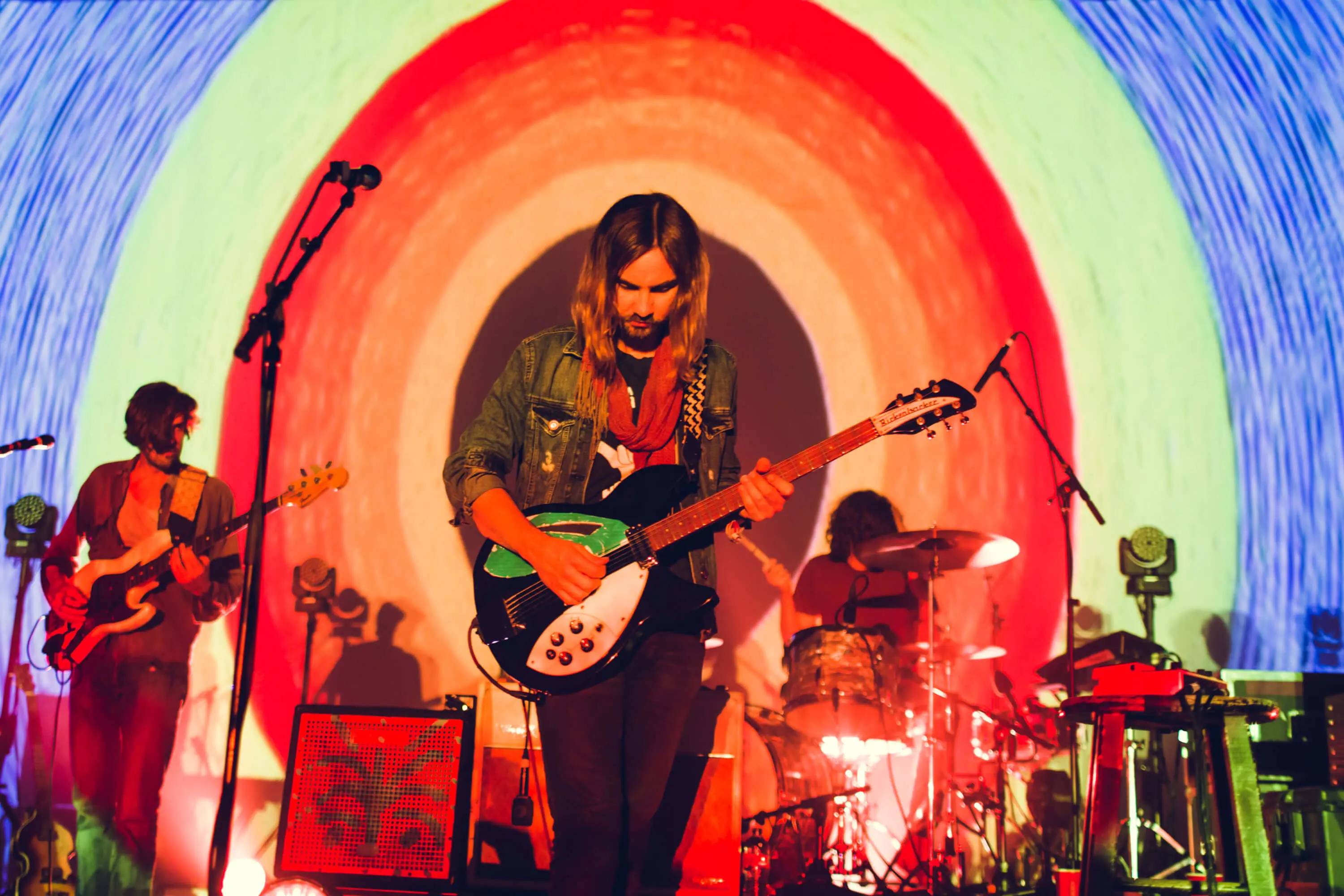 Tame Impala — poster held against glass wall reflection